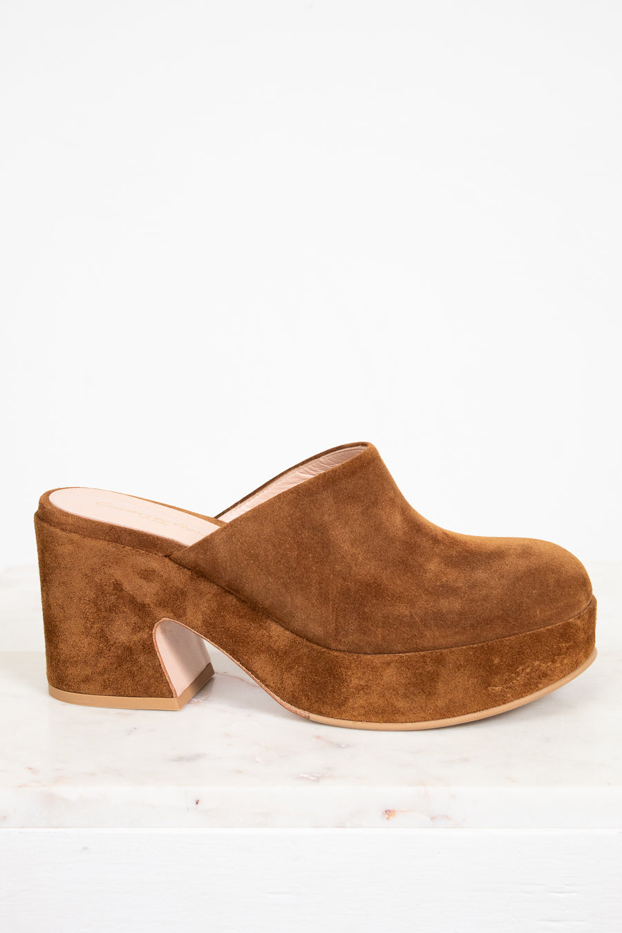 Brown suede clog shoe on a white background