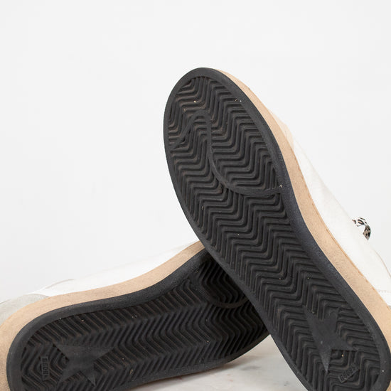 Close-up of a pair of shoes with black soles on a light background