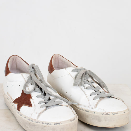 White and brown sneakers on a light gray background