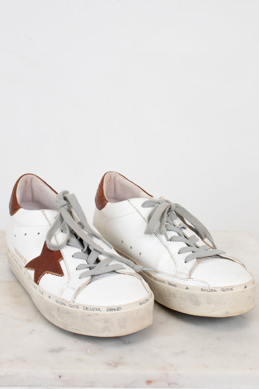 White and brown sneakers on a light gray background