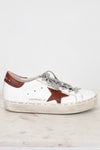 White sneaker with a brown star on a light gray background