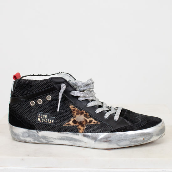 Black high-top sneaker with leopard print star on a white background