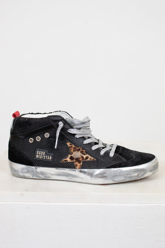Black high-top sneaker with leopard print star on a white background