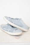 A pair of light blue mesh sneakers with white rubber soles, displayed on a light marble surface against a white background.