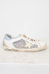 White sneaker with glittery details and star design and brand name on a white background