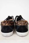 Black sneakers with leopard print accents on a light background