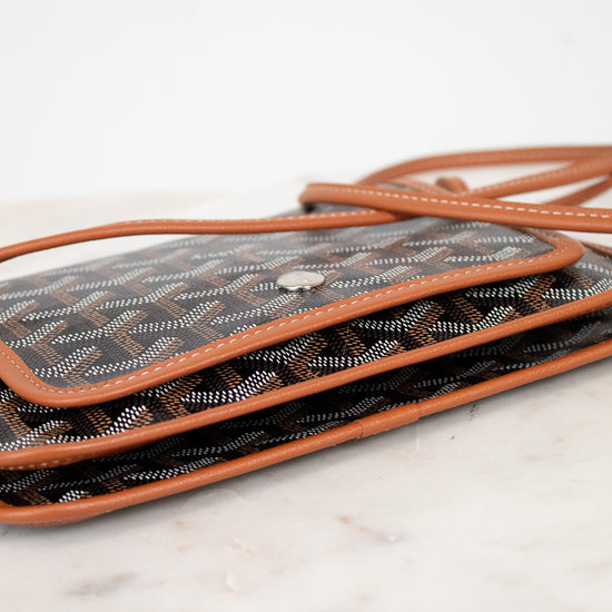 Designer handbag with visible brand pattern on a marble surface