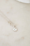 White gold diamond necklace on a marble surface