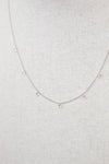 White gold diamond necklace on a fabric surface