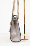 Gucci handbag with chain strap on a white background