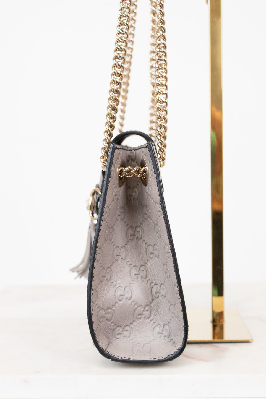 Gucci handbag with chain strap on a white background