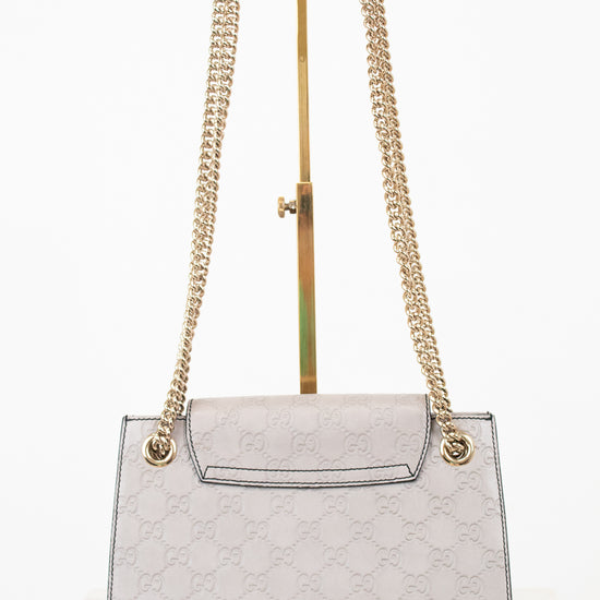 Gray handbag with gold chain strap on a white background