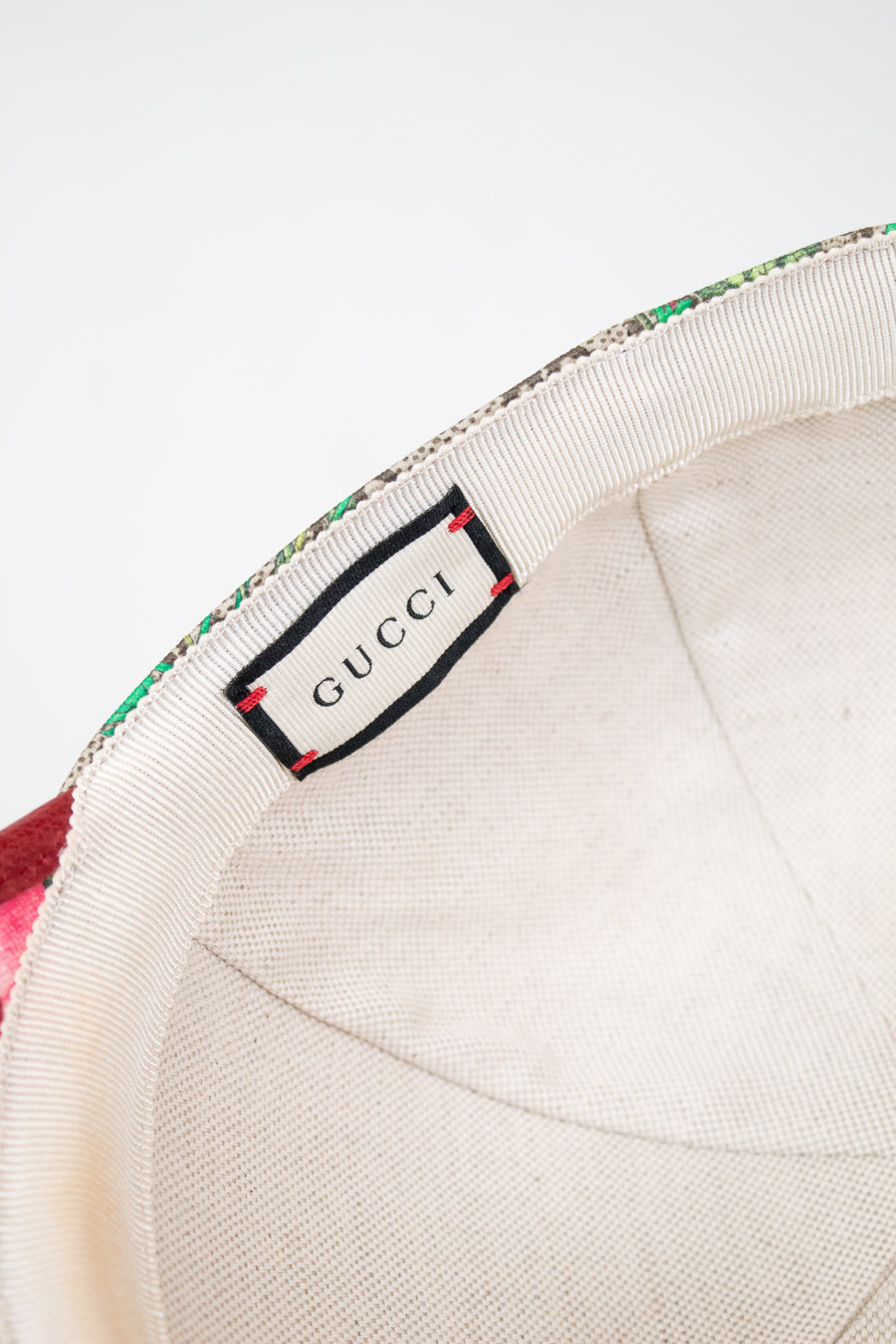 Gucci label on interior of hat with a white background
