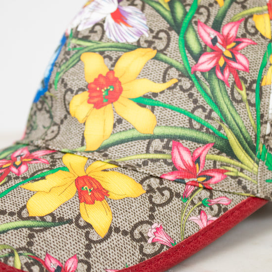 Floral-patterned cap with a red brim on a marble surface