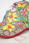 Floral-patterned cap with a red brim on a marble surface