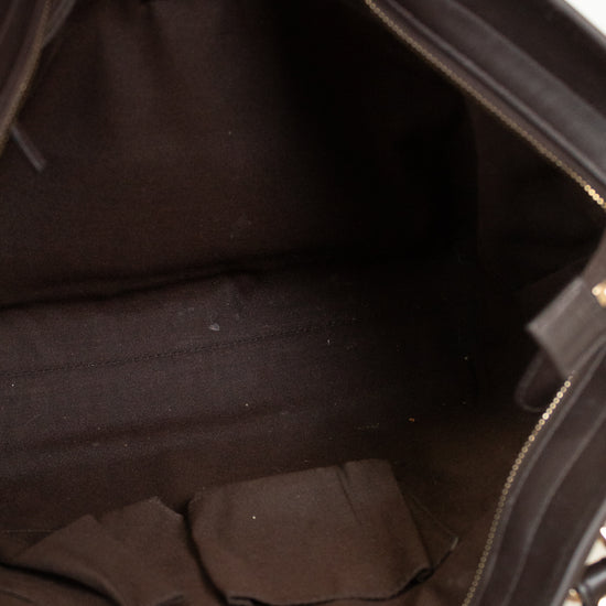 Close-up of a black handbag interior with visible stitching