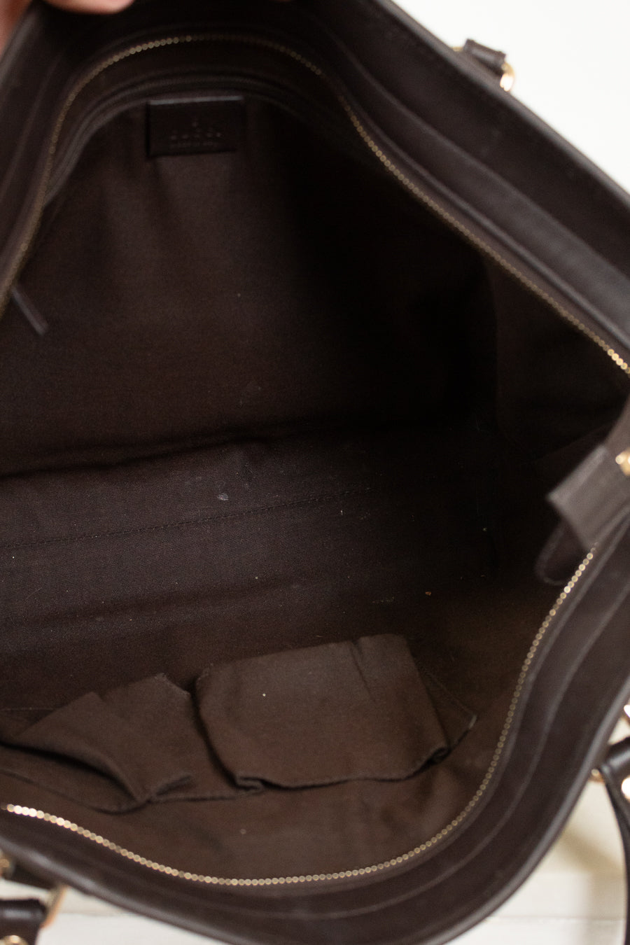 Close-up of a black handbag interior with visible stitching