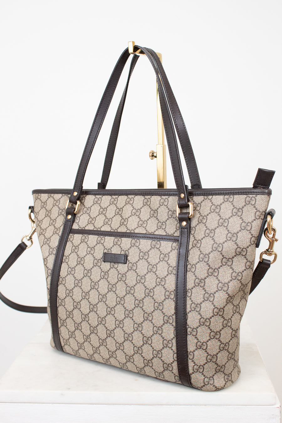 Designer handbag with a distinctive pattern on a white background