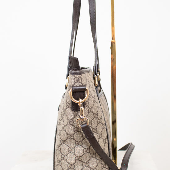 Designer handbag with monogram pattern on a white background