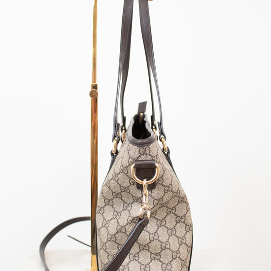 Designer handbag with monogram pattern on a white background