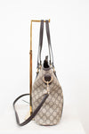 Designer handbag with monogram pattern on a white background