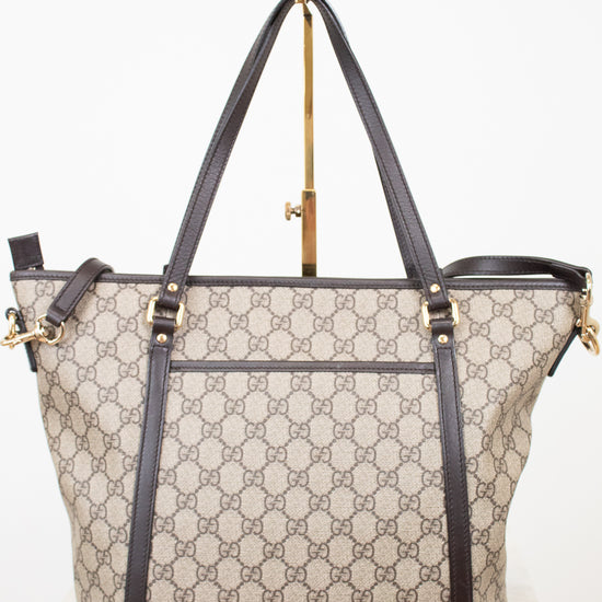 Designer handbag with monogram pattern on a white background