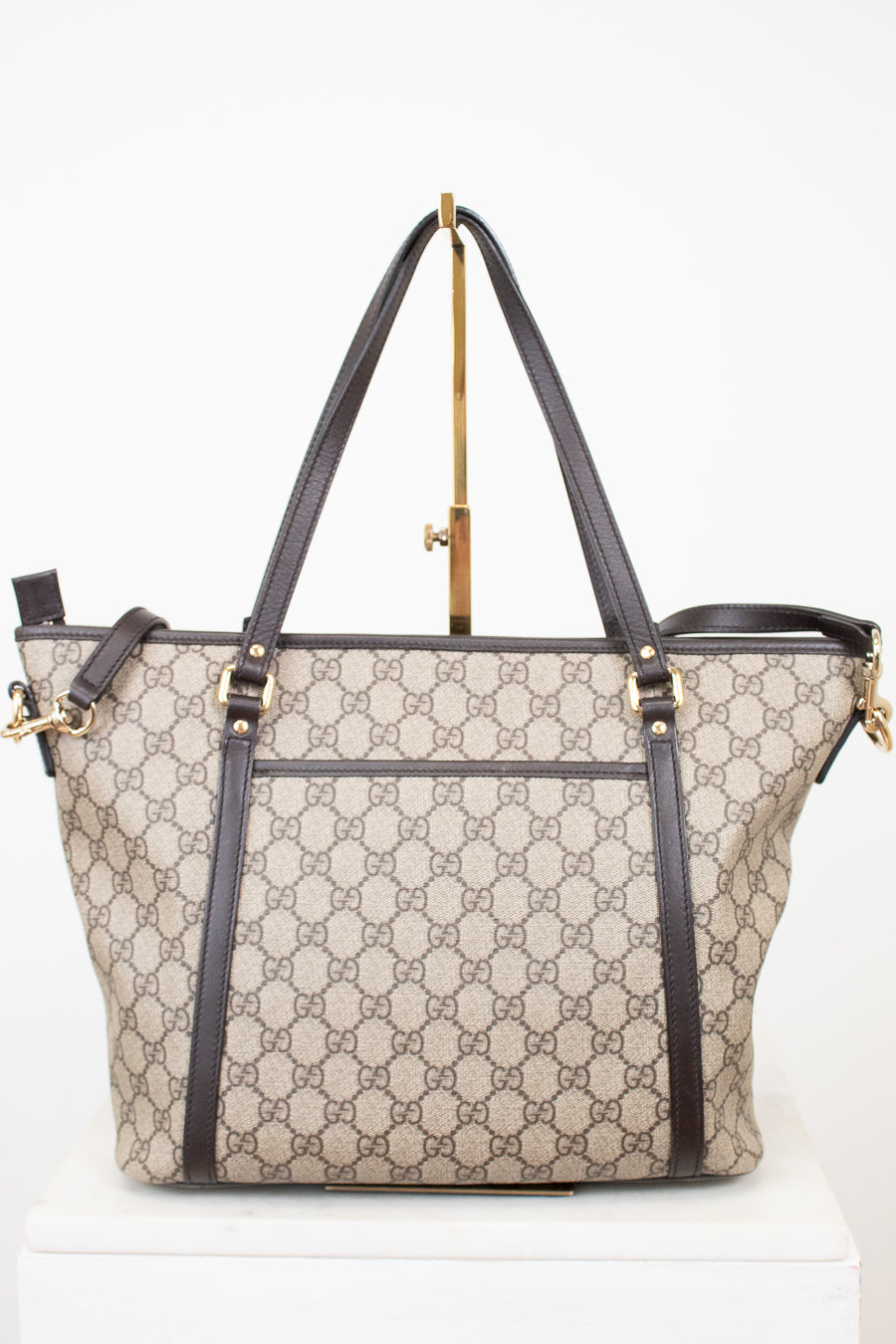 Designer handbag with monogram pattern on a white background