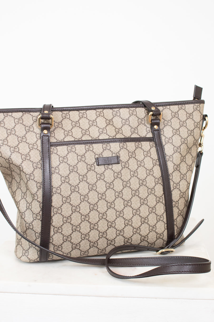 Beige handbag with brown accents on a white background