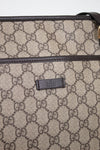 Gucci bag with monogram pattern and visible logo on a light gray background