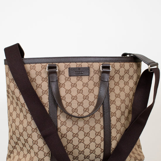 Beige and brown patterned handbag with a matching strap on a white background