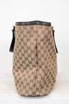 Beige handbag with brown Gucci logo pattern on a white background