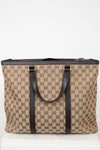 Beige and brown patterned tote bag with dark straps on a white background