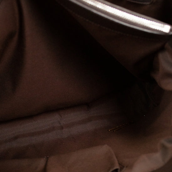Close-up of a brown garment with a zipper partially open