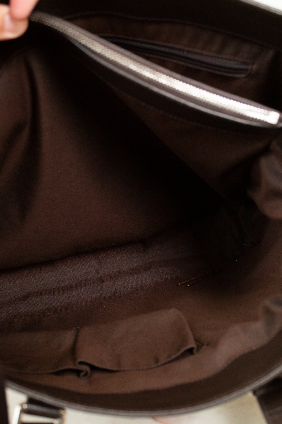 Close-up of a brown garment with a zipper partially open