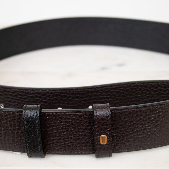 Black leather belt with a buckle on a white background