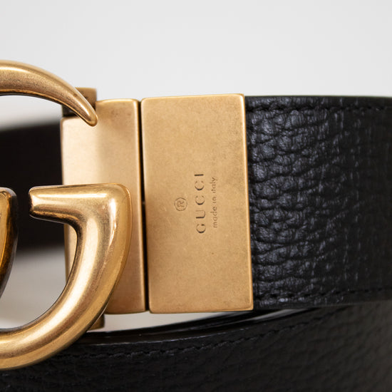 Close up of brand stamp on belt buckle on a light gray background
