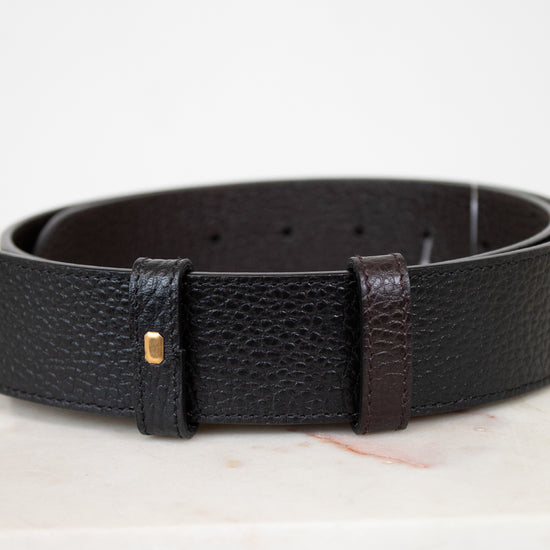 Black leather belt with a gold buckle on a white background
