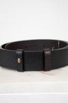 Black leather belt with a gold buckle on a white background