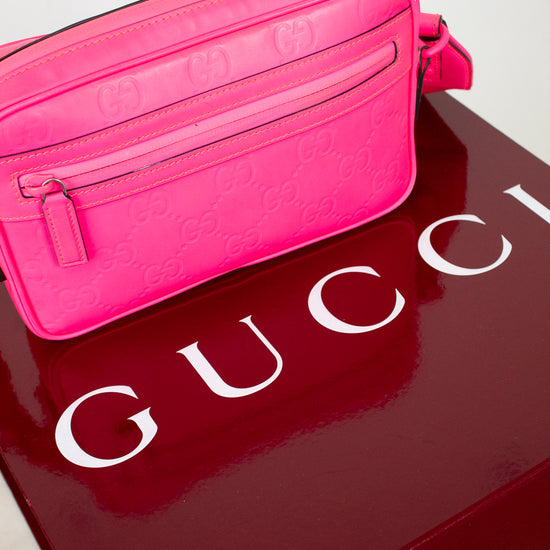 Pink Gucci bag on a red Gucci box