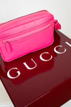 Pink Gucci bag on a red Gucci box