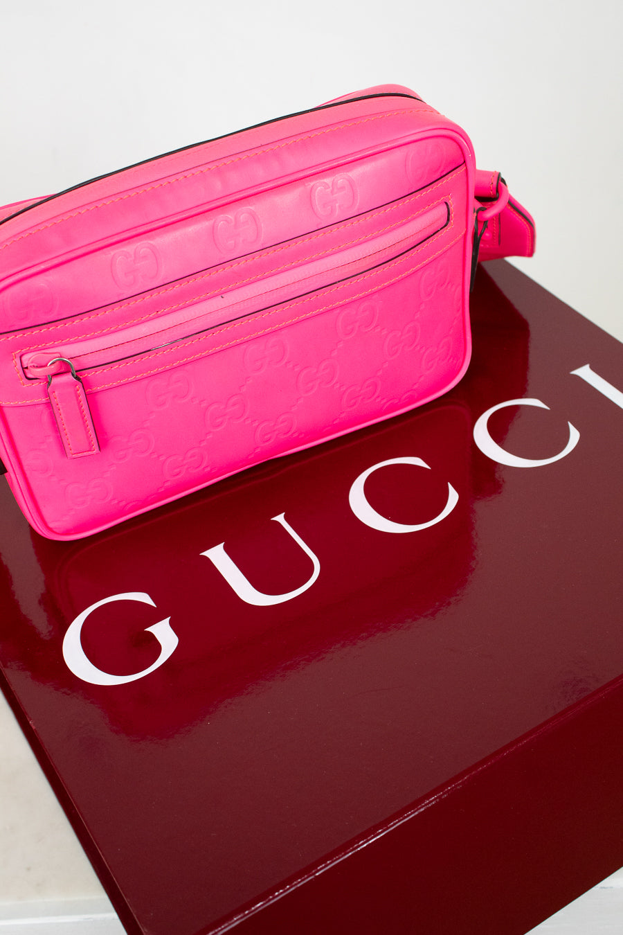 Pink Gucci bag on a red Gucci box