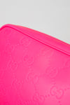 Close-up of a pink Gucci crossbody with a white background