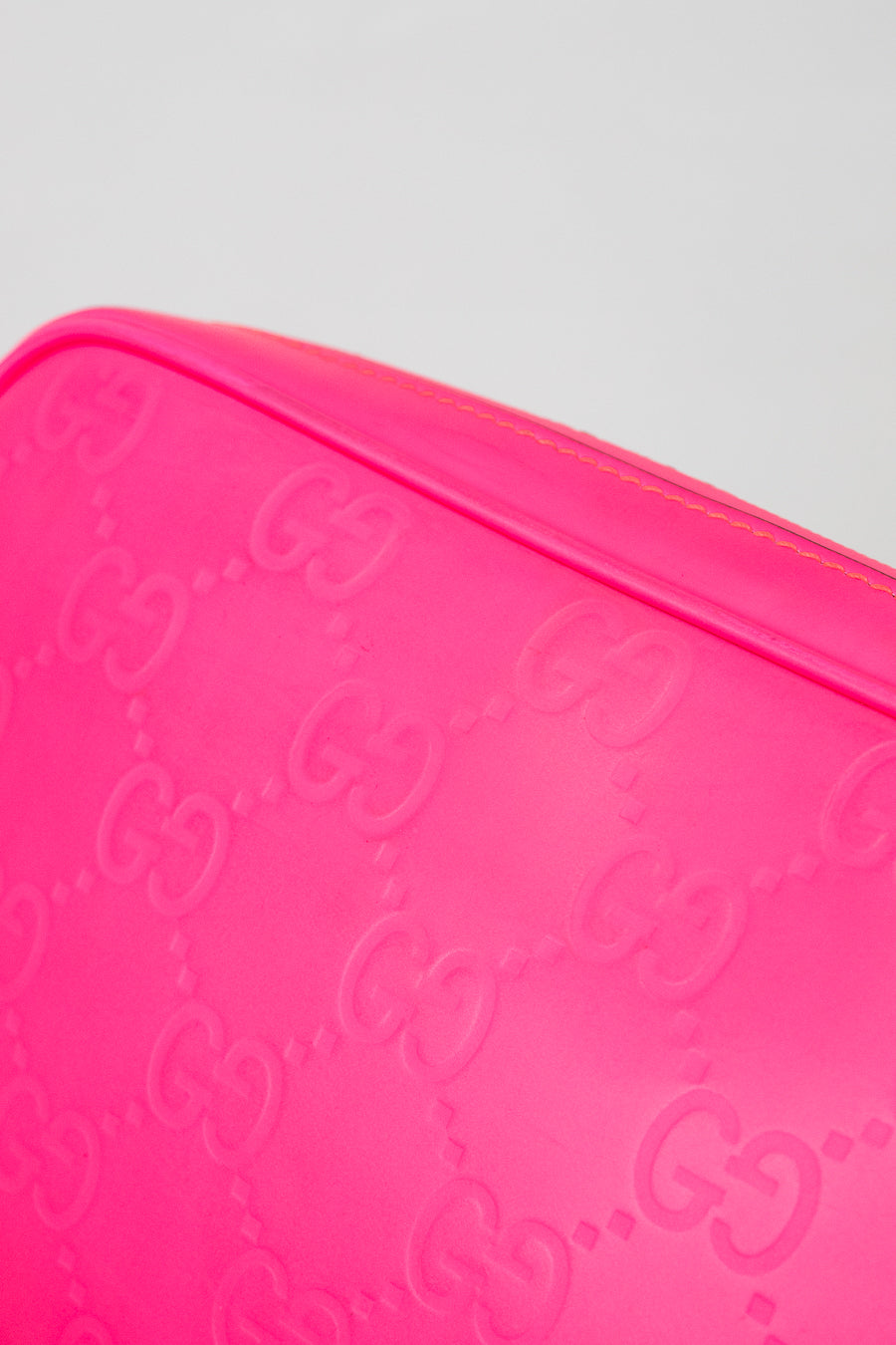 Close-up of a pink Gucci crossbody with a white background