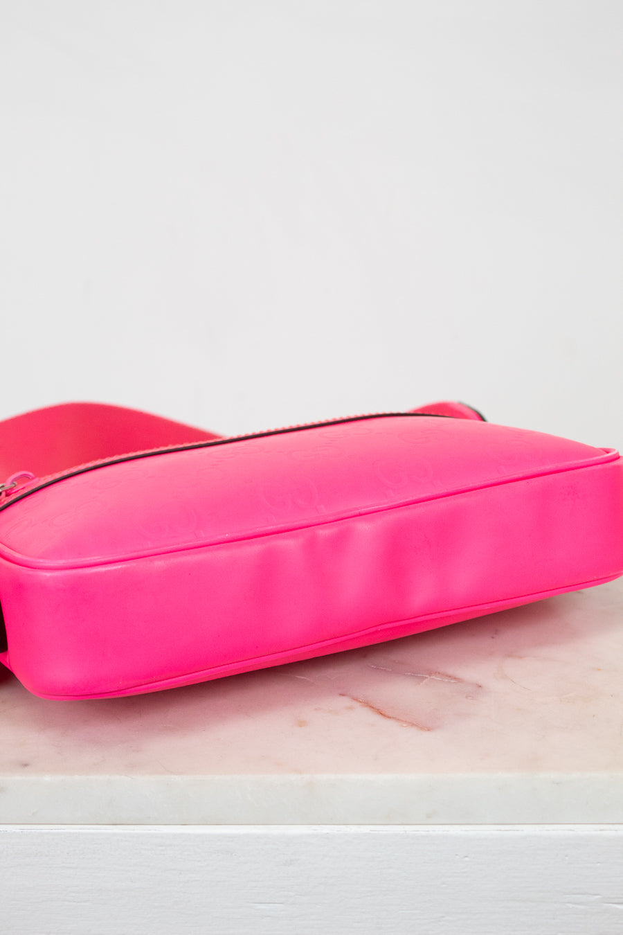Pink bag base view on a white surface