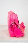 Pink crossbody side view on a white background