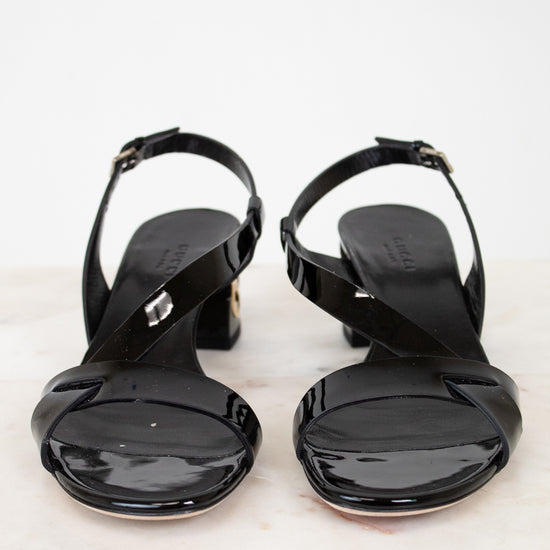 Pair of black high-heeled sandals on a white background