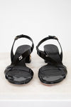 Pair of black high-heeled sandals on a white background
