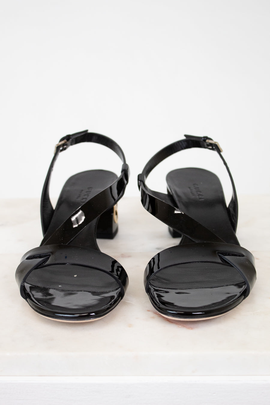 Pair of black high-heeled sandals on a white background