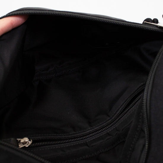 Close-up of a black bag with a zipper on a white background