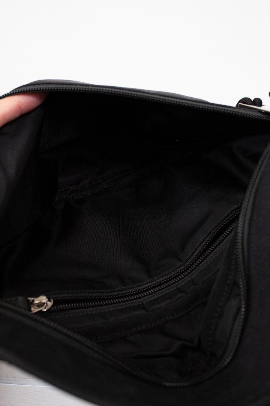Close-up of a black bag with a zipper on a white background